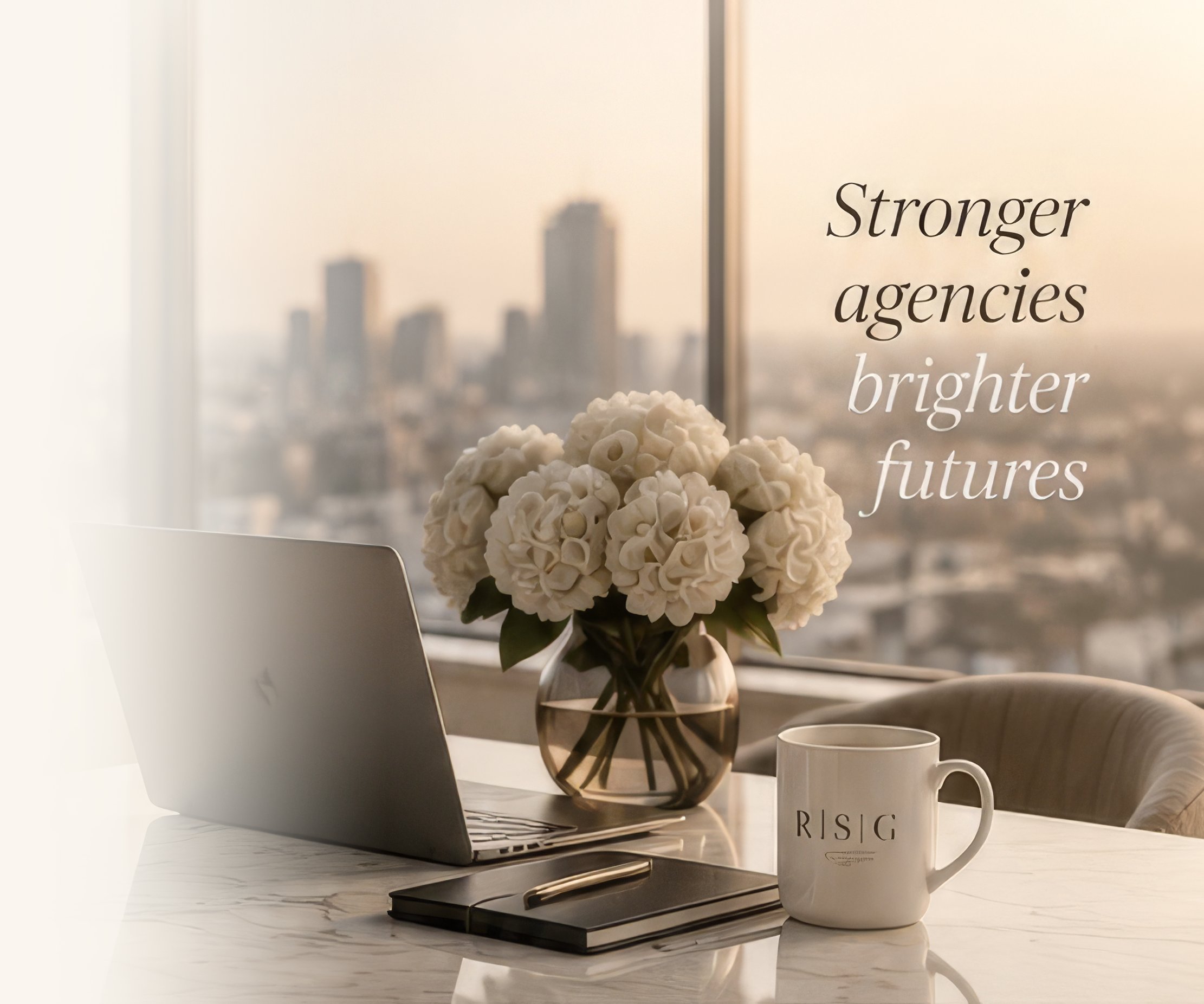 Laptop, hydrangeas and an RSG mug on a marble desk overlooking a city skyline, with the words Stronger agencies, brighter futures